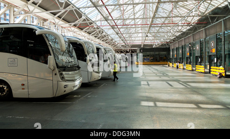 View of a row of National Express buses, roof and person in the interior of Victoria Coach Station London England UK Great Britain Stock Photo
