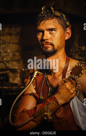 Hephaestus blacksmith in a leather apron, put his right hand to his heart Stock Photo