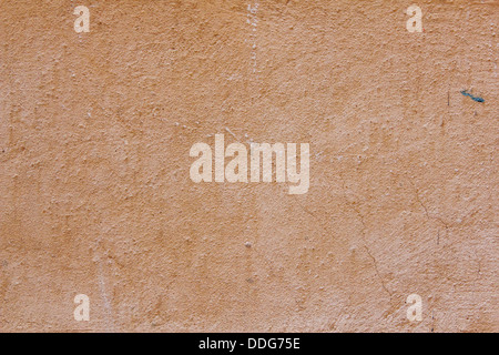 close-up view of terracotta colored rough plaster wall Stock Photo