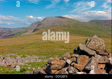 A view of Cader Idris, showing the pony path rising up to the summit, with a cairn of rocks in the near right foreground. Stock Photo