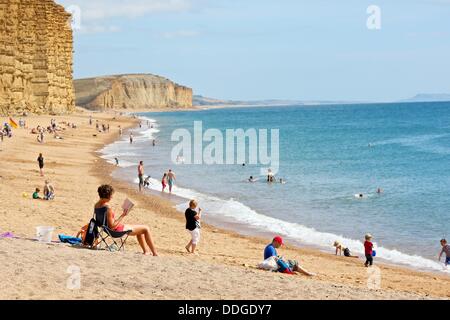 West Bay, Dorset, UK. 2 September 2013. As summer holidays come to an end the sun still shines on Dorset's Jurassic Coast allowing those who remain to enjoy the nearly empty beach with the good weather looking set to continue. Credit:  Tom Corban/Alamy Live News Stock Photo