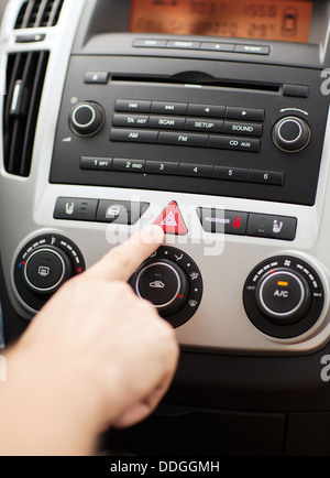 man pressing car hazard warning button Stock Photo
