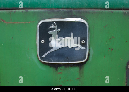 John Deere badge on front of old farm tractor Stock Photo