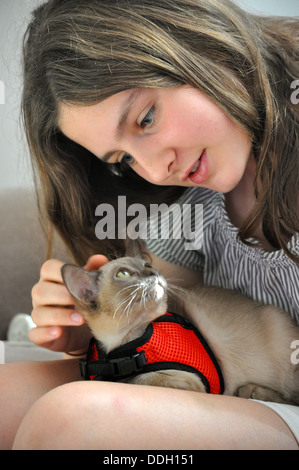 Portrait of girl stroking and cuddling her cat Stock Photo