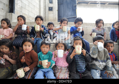 Guatemalan indigenous children drink a cup of atole at preschool in Tierra Linda, Solola, Guatemala. Stock Photo