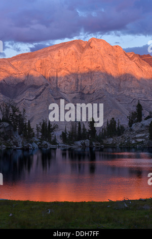 Alpenglow on Matterhorn peak reflected in a lake high in Oregon's Wallowa Mountains. Stock Photo