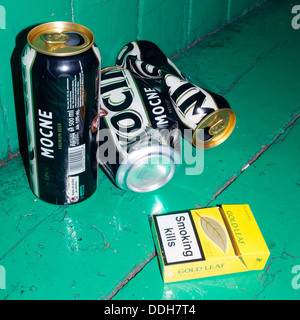 Empty beer cans on park bench Stock Photo