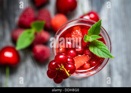 Closeup of liqueur made of fresh wild berries and mint Stock Photo