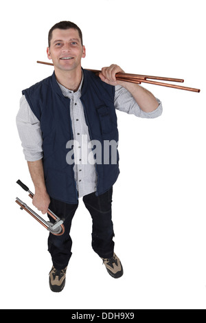 Plumber holding copper pipe Stock Photo