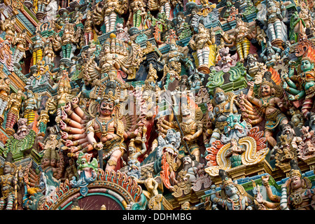 Colourful statues of gods and demons on the Gopuram or Gopura gate tower, Meenakshi Amman Temple or Sri Meenakshi Sundareswarar Stock Photo