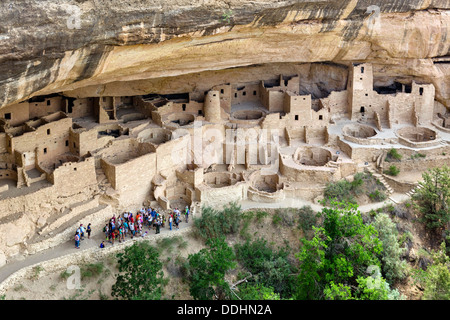 Group of tourists visiting the Cliff Palace, ancient Anasazi pueblo dwellings, Mesa Verde National Park, Cortez, USA. Cliff dwelling. Stock Photo