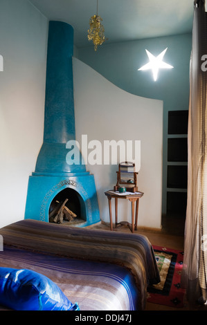 Bedroom of Riad in Marrakesh Medina with traditional chimney flue and star-shaped light fitting Stock Photo