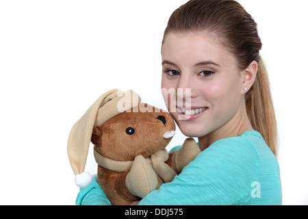 Teenage girl hugging cuddly toy Stock Photo