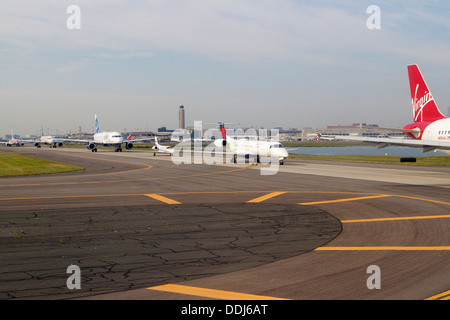 Boston Logan Airport runway with airplanes lined up ready for take off Stock Photo