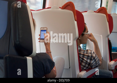 Passengers working on train Stock Photo