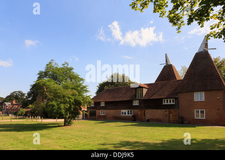 Former old Oast houses converted into unusual homes on a village green in Littlebourne, Canterbury, Kent, England, UK, Britain Stock Photo