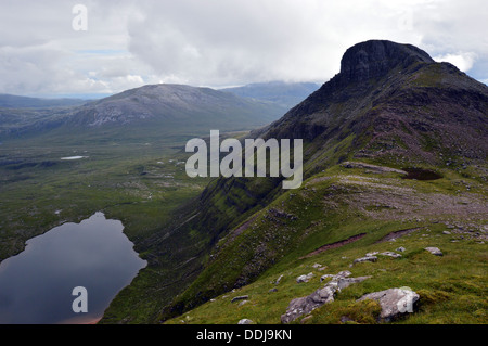 The Scottish mountain Spidean Coinich (a Corbett) on Quinag with Lochan Bealach Cornaidh seen from the ridge to the north. Stock Photo