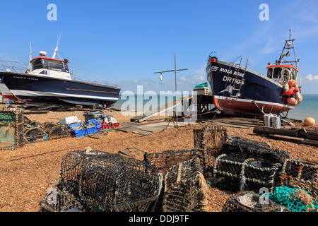 Fishing boats and lobster pots on the south coast seafront shingle beach in Deal, Kent, England, UK, Britain Stock Photo