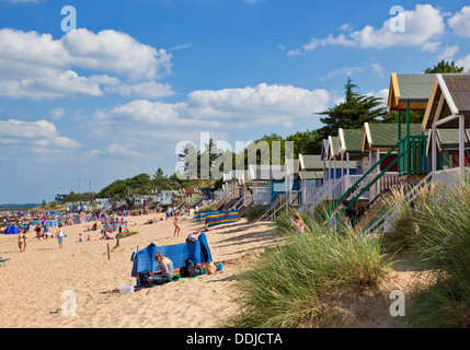 Busy Beach and beach huts at Wells next the sea North Norfolk coast England UK GB EU Europe Stock Photo