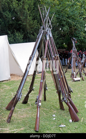 A rifle stack in a French re-enactment group tent camp close to the Butte du Lion on the Waterloo battlefield, Belgium. Stock Photo