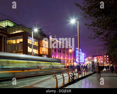 Luas bringing Christmas shoppers into Dublin Ireland, night time at St Stephens Green and Grafton Street Stock Photo
