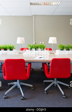 Flexible work spaces with power outlets in a modern open office interior design Stock Photo