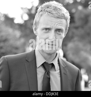 Blonde man in suit with tie in Black and White Stock Photo