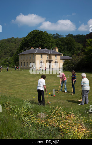 A group of women playing croquet on the lawn at Llanercheron Hall, a National Trust property near Aberaeron Wales UK Stock Photo