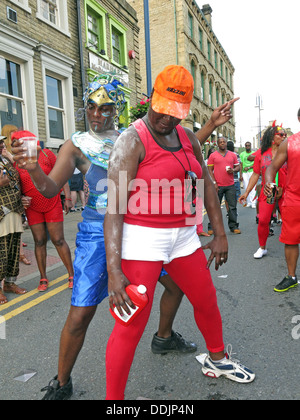 Costumed dancers with talc from Huddersfield Carnival 2013 African Caribbean parade street party Stock Photo