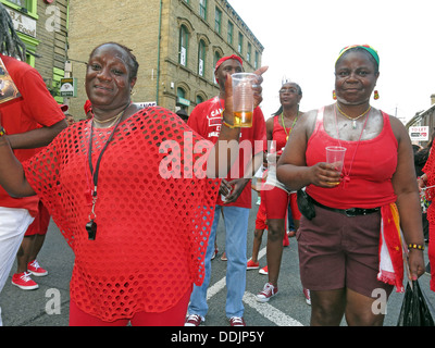 Costumed dancers in red from Huddersfield Carnival 2013 African Caribbean parade street party Stock Photo