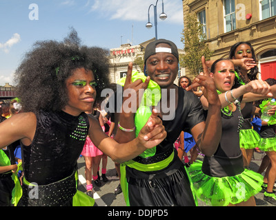 Costumed dancers in green from Huddersfield Carnival 2013 African Caribbean parade street party Stock Photo