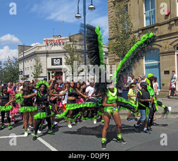 Costumed dancers in green from Huddersfield Carnival 2013 African Caribbean parade street party Stock Photo