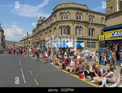 Crowds await costumed dancers from Huddersfield Carnival 2013 African Caribbean parade street party Stock Photo