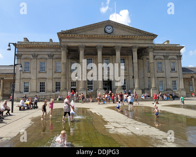 Square outside Huddersfield railway station with fountains and sculpture of Harold Wilson by Ian Walters Stock Photo