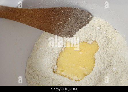 plain flour and beaten eggs in mixing bowl Stock Photo