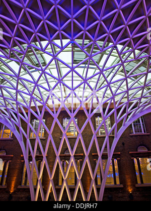 Detail of the steel lattice-work roof structure engineered by Arup, on the western concourse of King's Cross railway Station. Stock Photo