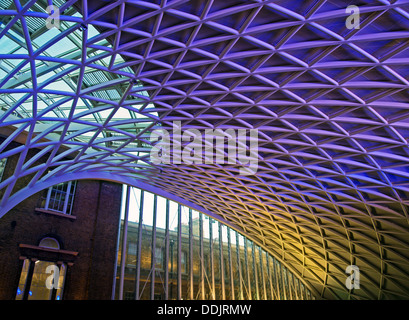 Detail of the steel lattice-work roof structure engineered by Arup, on the western concourse of King's Cross railway Station. Stock Photo