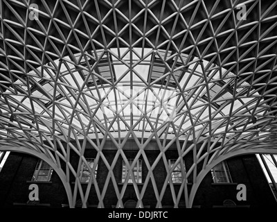 Detail of the steel lattice-work roof structure engineered by Arup, on the western concourse of King's Cross railway Station. Stock Photo