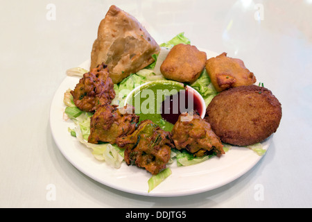 East Indian Food Appetizer Starter Dish with Samosa Pakoras Vegetable Cutlets with Chutney Tamarind Dipping Sauce Stock Photo
