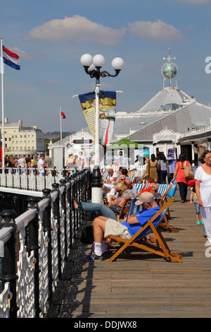 Holidaymakers snoozing in the sun on Brighton Pier, East Sussex, England, UK Stock Photo