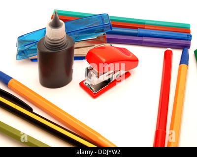 Felt-tip pens, stapler and paint on a white background Stock Photo