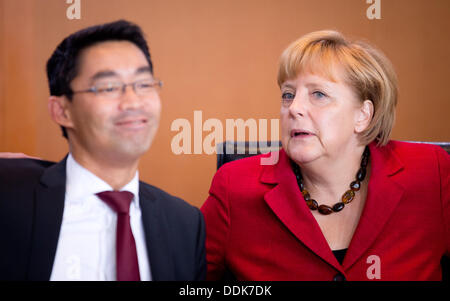 the German Chancellery, Berlin, Germany. 04th Sep, 2013. German Chancellor Angela Merkel and Economy Minister Philipp Roesler chat before the cabinet meeting at the German Chancellery, Berlin, Germany, 04 September 2013. Photo: Kay Nietfeld/dpa/Alamy Live News Stock Photo