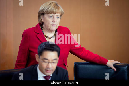 the German Chancellery, Berlin, Germany. 04th Sep, 2013. German Chancellor Angela Merkel and Economy Minister Philipp Roesler chat before the cabinet meeting at the German Chancellery, Berlin, Germany, 04 September 2013. Photo: Kay Nietfeld/dpa/Alamy Live News Stock Photo