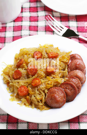Braised cabbage with grilled sausage on a table Stock Photo