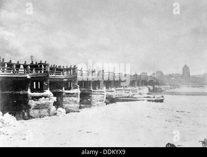 People looking at the frozen Thames from Old Putney Bridge looking South, Putney, London, c1881. Artist: Unknown Stock Photo