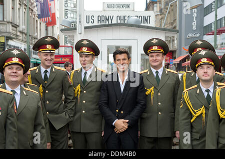 Berlin, Germany. 4th Sep, 2013. French singer Vincent Nicolo (C) performs with members of the 'Red Army Choir' at Checkpoint Charlie in Berlin, Germany, 4 September 2013. The 'Red Army Choir' is considered one of the most famous music ensembles in the world. Photo: Soeren Stache/dpa/Alamy Live News Stock Photo