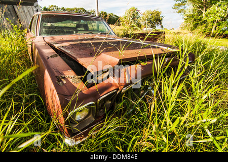 old wrecking car in countryside in Maine, Usa Stock Photo