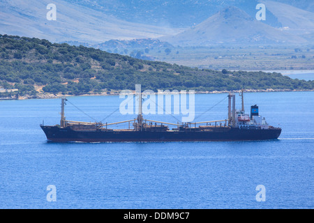 The cargo ship Reina Christina carrying timber in the straits between Corfu and Albania Stock Photo