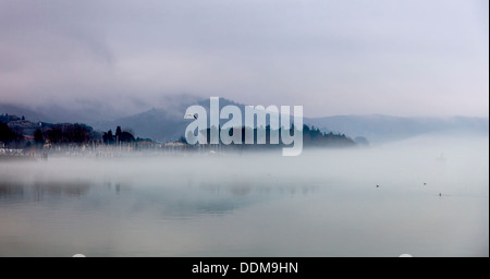 Foggy evening in Passignano at Lake Trasimeno, Umbria, Italy Stock Photo