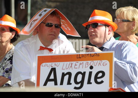 Visitors of an election campaign event of the Christian Democratic Party with German Chancellor Angela Merkel hold a sign with the lettering 'Angie' in their hands in Trier, Germany, 04 September 2013. Photo: THOMAS FREY Stock Photo